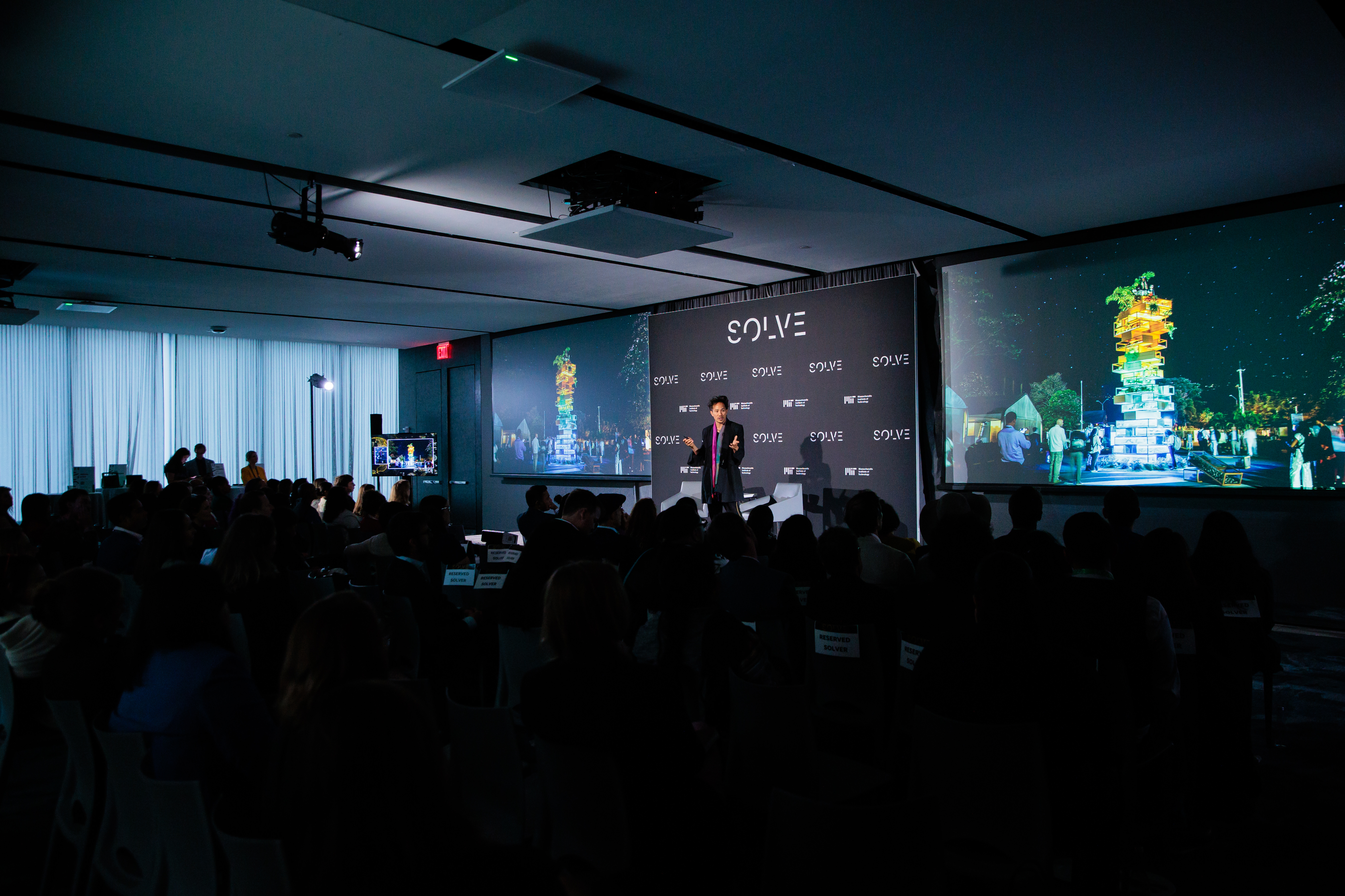 Von Wong speaking on stage at SOLVE